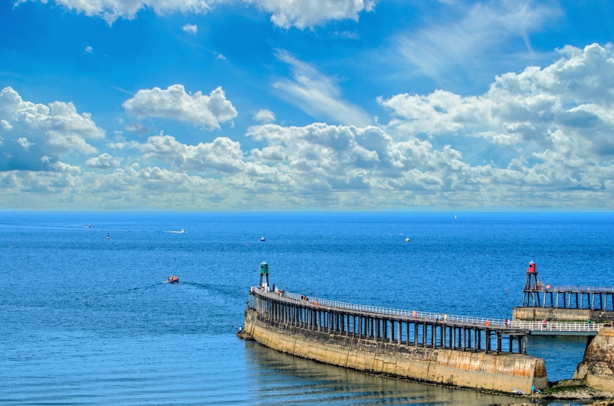Pictures of stone bridge with blue sea and blue sky