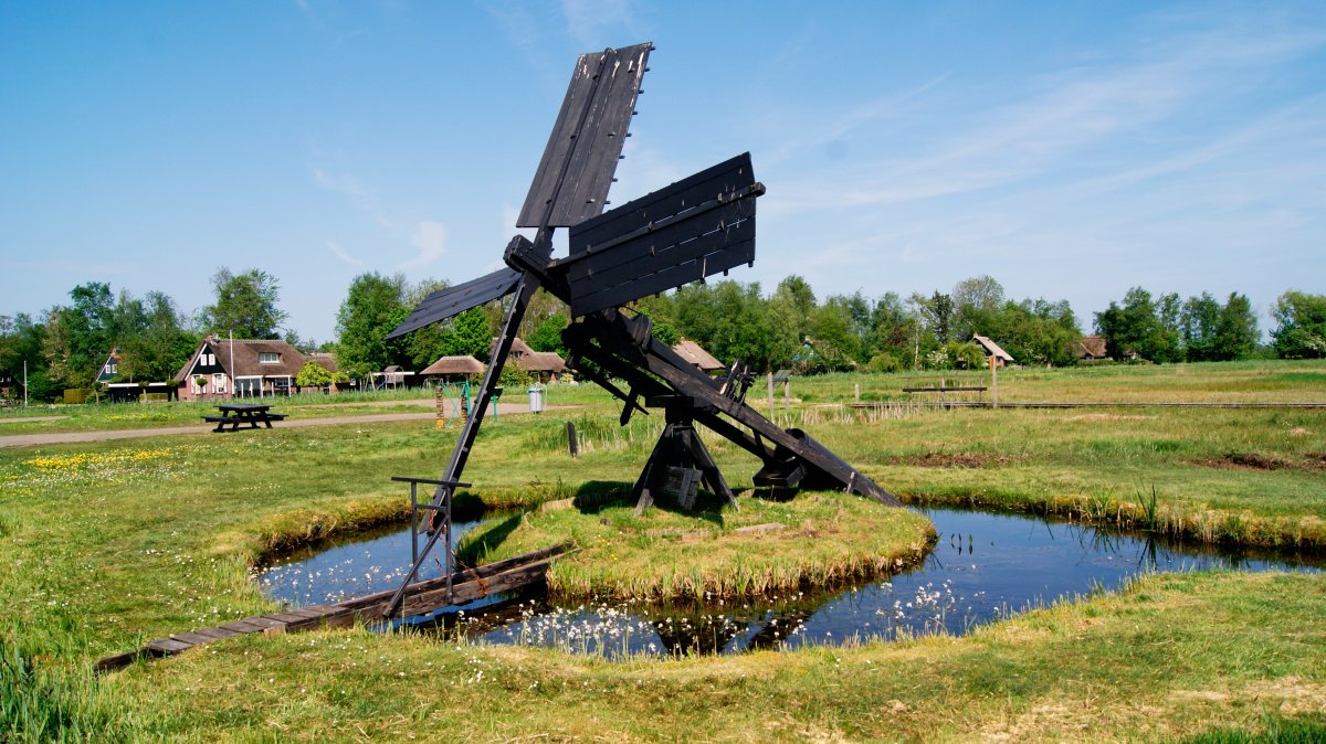 Picture of dilapidated windmill on grass