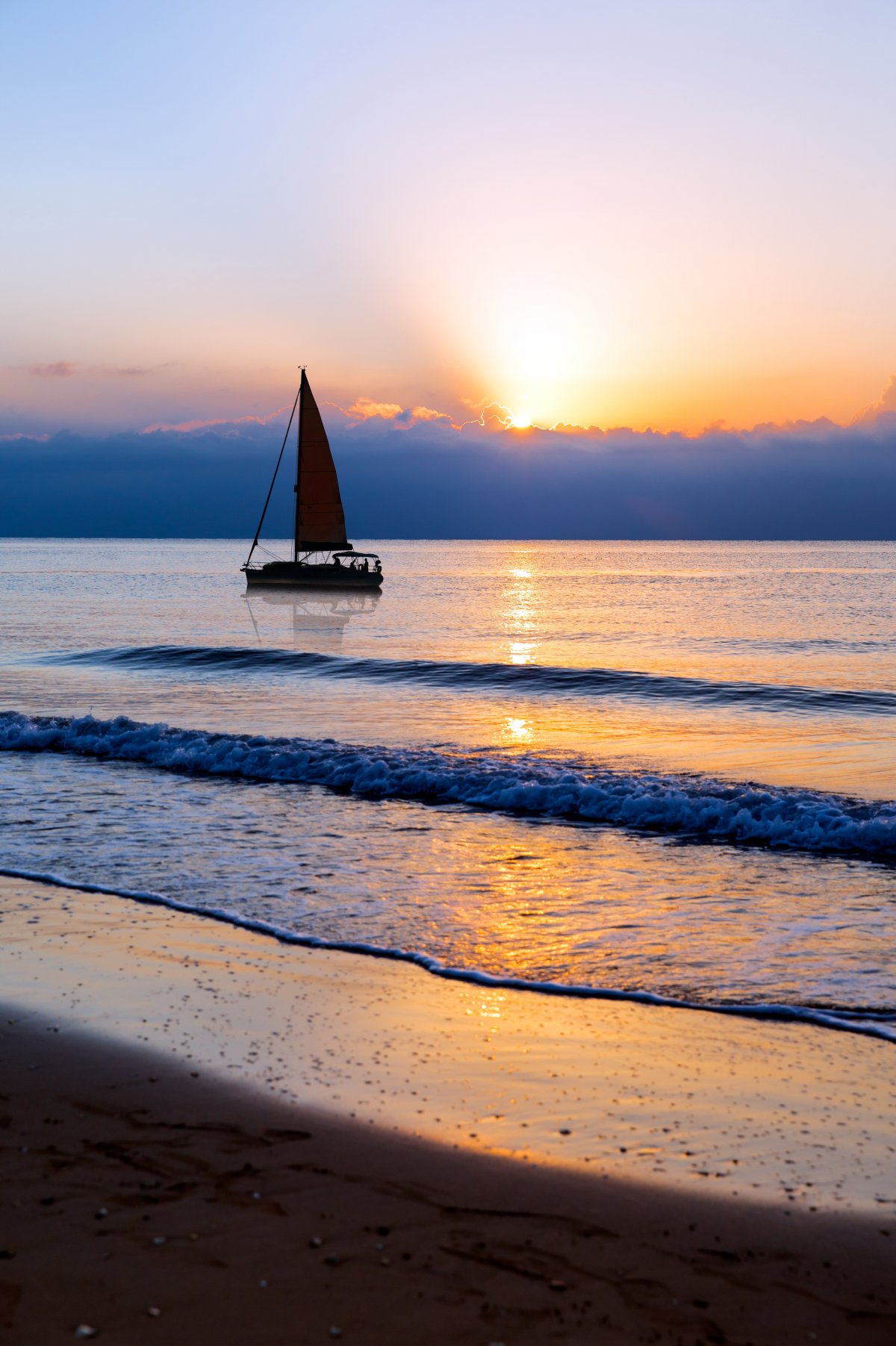 Picture of sailing boat at sunrise on the sea