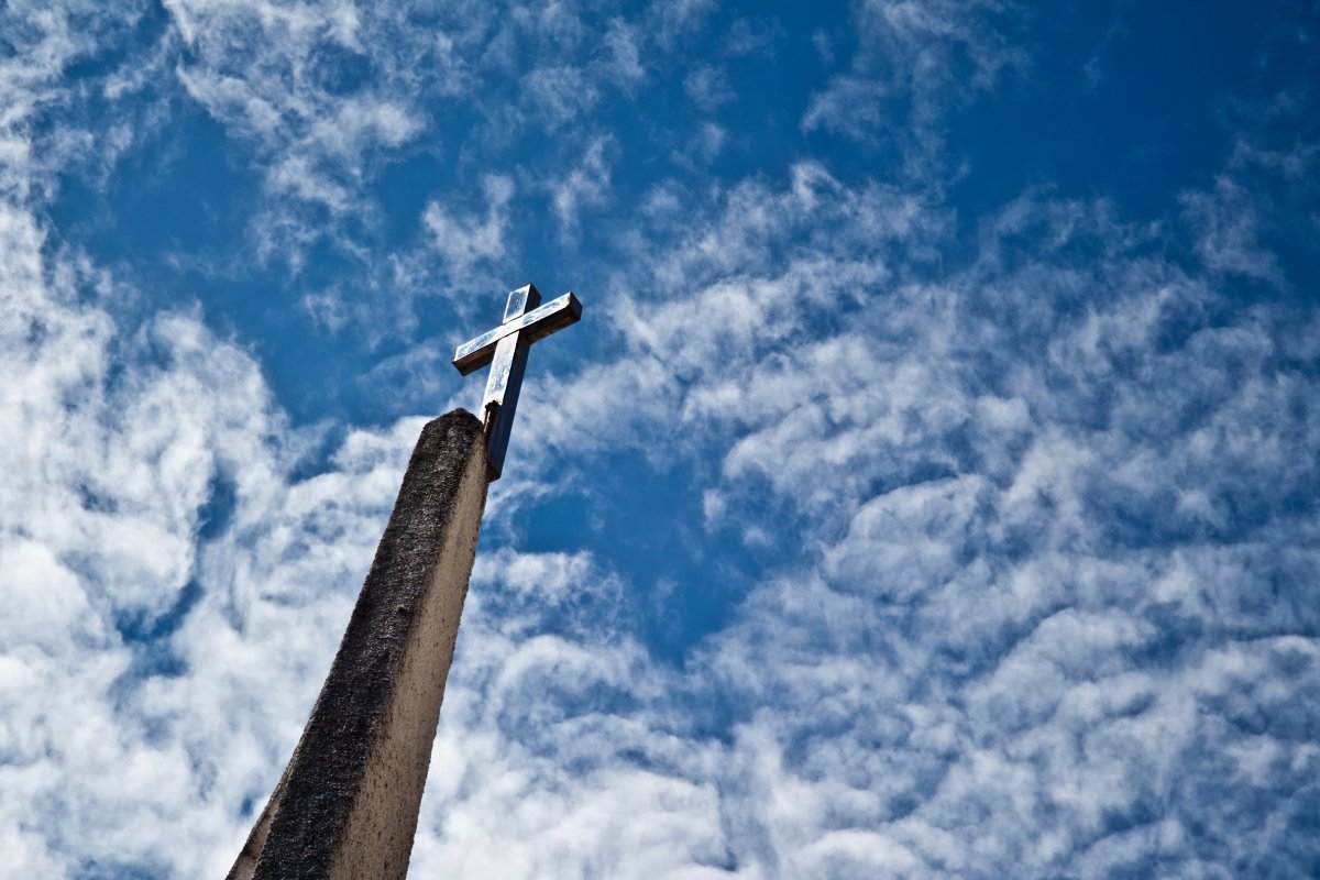 Picture of cross with blue sky and white clouds