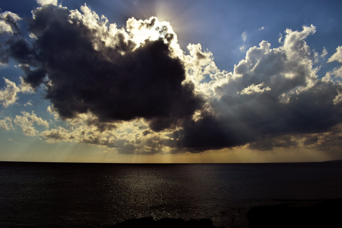 Pictures of dark clouds covering the sun on the sea