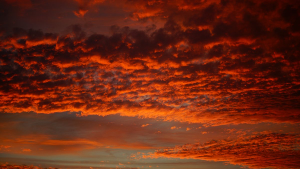 Landscape picture of burning clouds in the sky at dusk