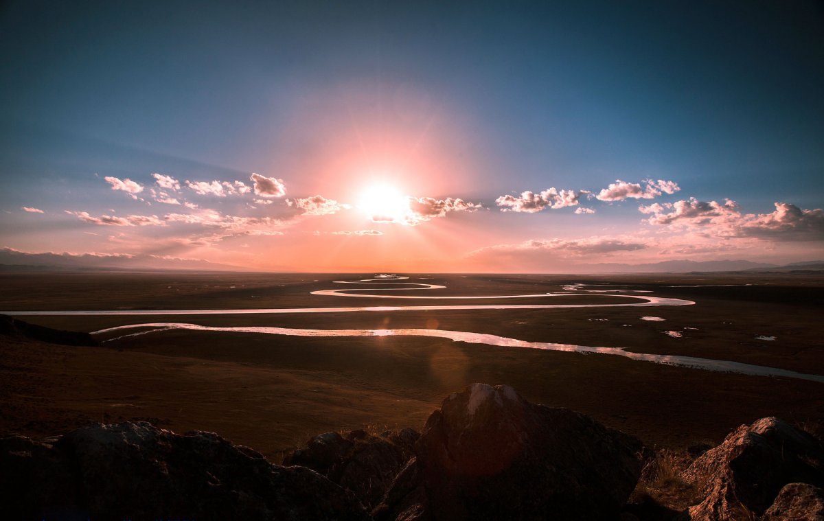 Sunrise picture of meandering river in grassland