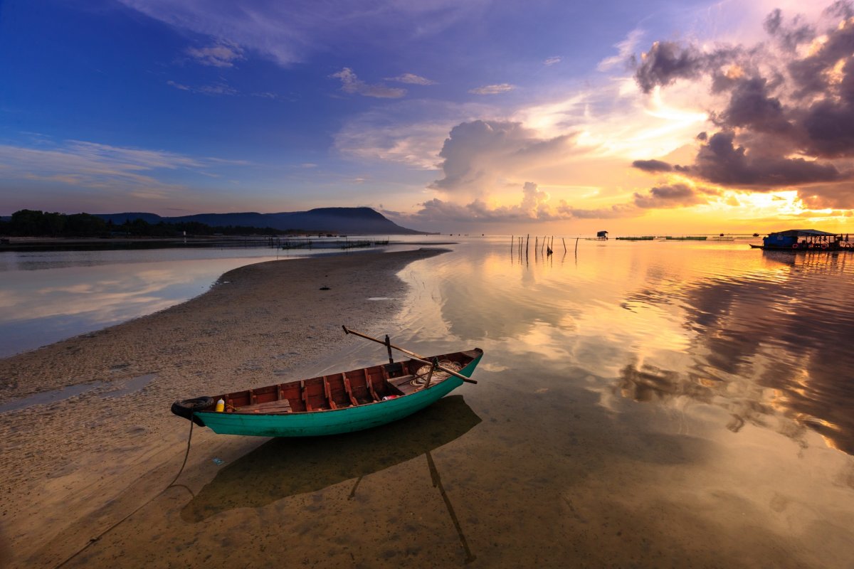 Pictures of fishing boats on the beach at dusk